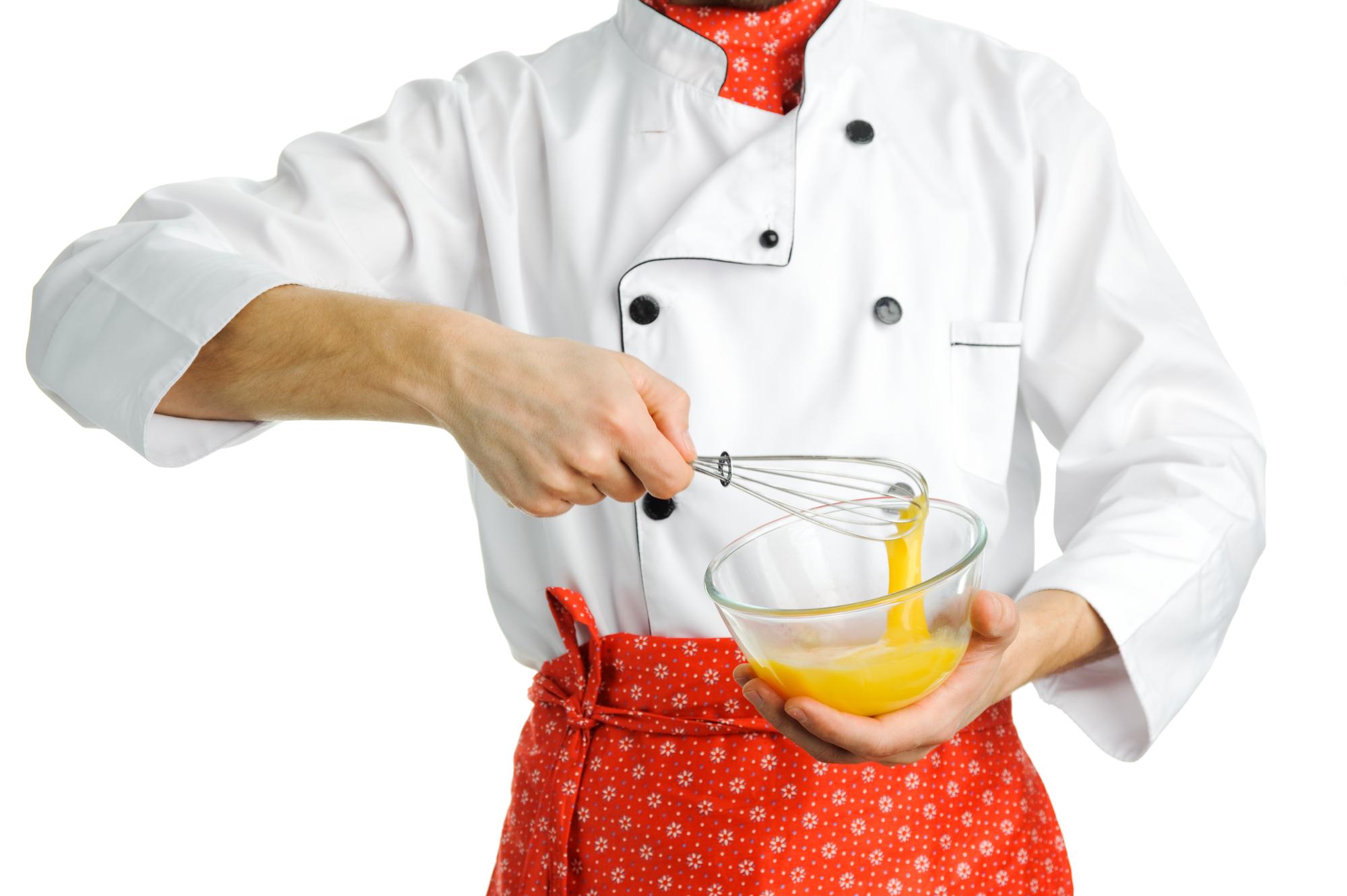 Close-up of hands seasoning a dish